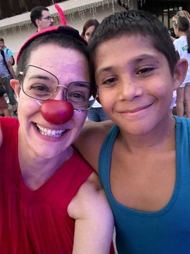 Titania Chaos smiling in the camera with a Roma boy, a participant at the social circus workshop in Triavna, Bulgaira, 2024. 